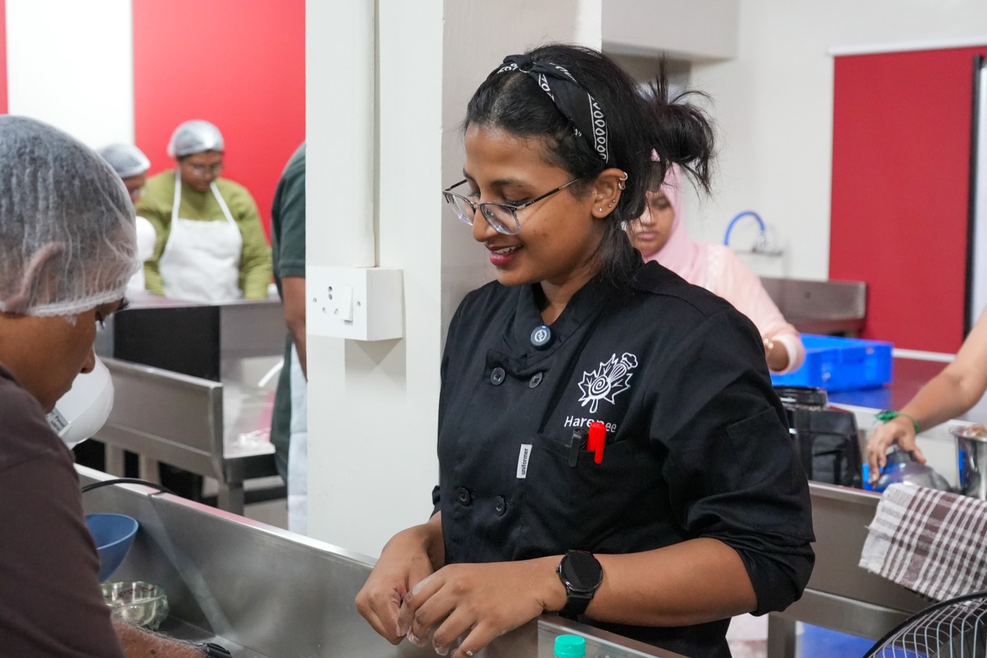 Chef Harenee working alongside a student at the kitchen counter