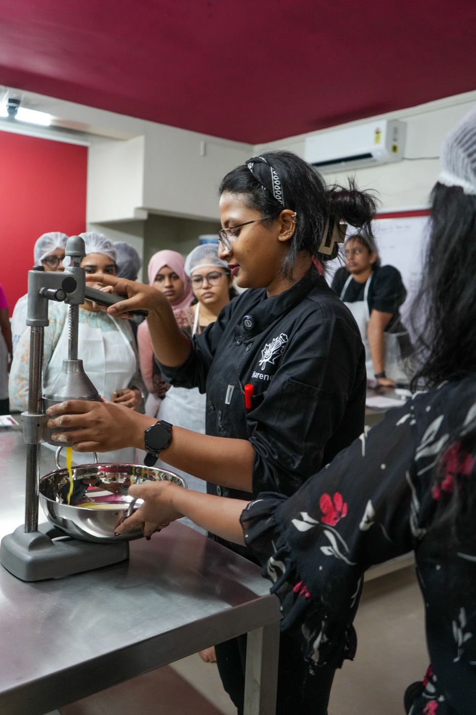 Instructor demonstrating on professional baking equipment