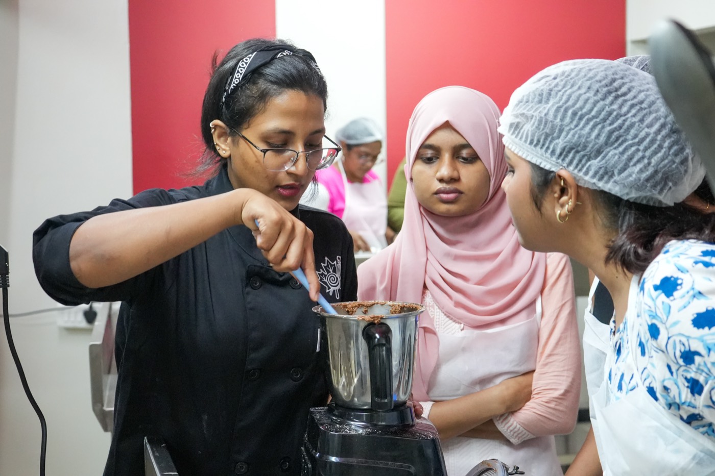 Students learning hands-on at the mixer